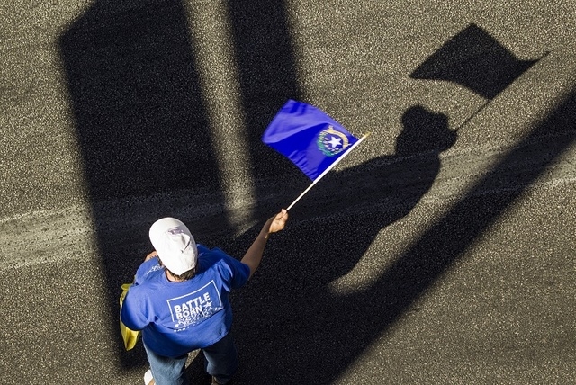Jamie Makaron waves the Nevada state flag during the Nevada Day Parade on Fourth Street in downtown Las Vegas on Friday, Oct. 31. Thousands lined the street to celebrate Nevada's  Sesquicentennial ...