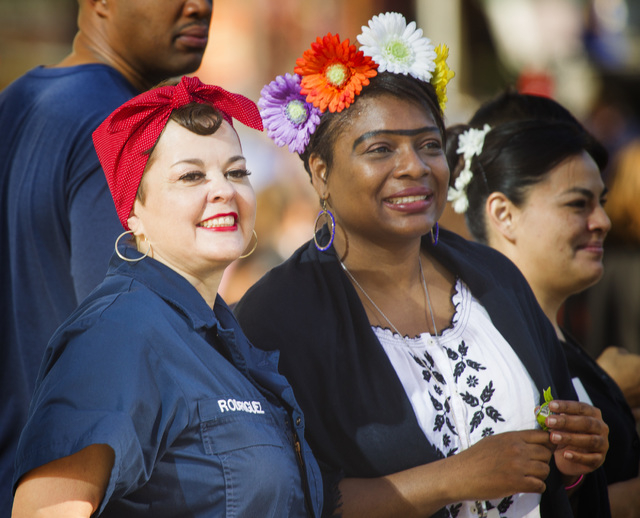 Alicia Cantu,left, and Marsha Palrose watch the Nevada Day Parade on Fourth Street in downtown Las Vegas on Friday, Oct. 31. Thousands lined the street to celebrate Nevada's Sesquicentennial. (Je ...