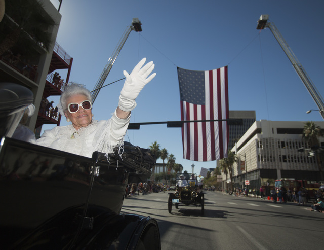 Joan Doubrava waves while participating in the Nevada Day Parade on Fourth Street in downtown Las Vegas on Friday, Oct. 31. Thousands lined the street to celebrate Nevada's Sesquicentennial. (J ...