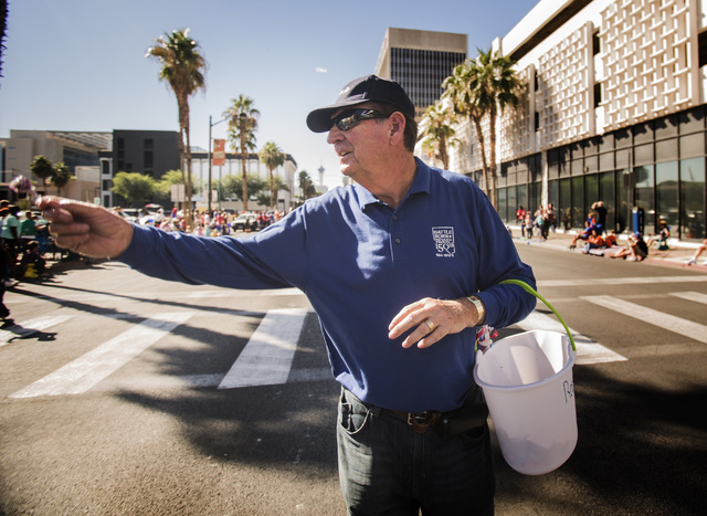 Former Gov. Bob Miller hands out candy in the Nevada Day Parade on Fourth Street in downtown Las Vegas on Friday, Oct. 31. Thousands lined the street to celebrate Nevada's Sesquicentennial. (Jef ...