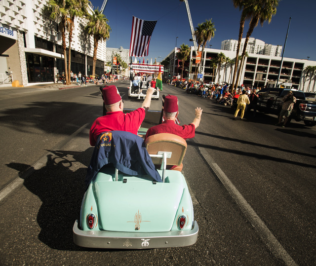 Zelzah Shriners Las Vegas Jerry Eitel, left, and Jim Denney wave during the   Nevada Day Parade on Fourth Street in downtown Las Vegas on Friday, Oct. 31. Thousands lined the street to celebrate N ...