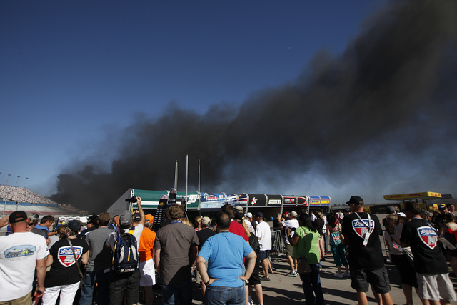 Smoke billows from a fire at the Red Bull Air Race World Championship race at the Las Vegas Motor Speedway in Las Vegas on Sunday, Oct. 12, 2014. A firefighter was injured battling the blaze.(Just ...