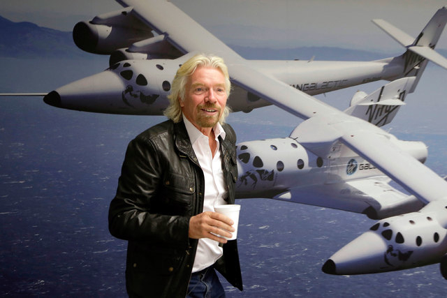 British entrepreneur Richard Branson is shown at the Virgin Galactic hangar at Mojave Air and Space Port in Mojave, California, Sept. 25, 2013. A Virgin Galactic suborbital passenger spaceship cra ...