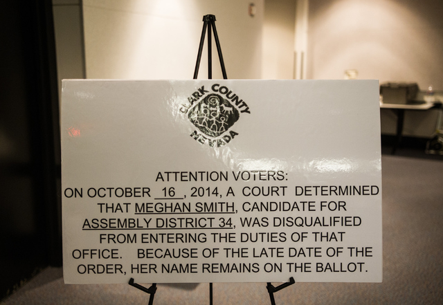 A sign stating that Assembly District 34 candidate Meghan Smith has been disqualified is seen at the early voting polling site at Sahara West Library in Las Vegas on Wednesday, Oct. 22, 2014. The  ...