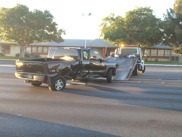 A tow truck prepares to remove a truck involved in an accident at Tropicana Avenue and Swenson Street Friday morning, Oct. 31, 2014. (Bizu Tesfaye/Las Vegas Review-Journal)