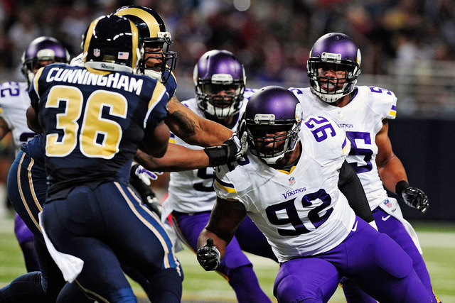Minnesota Vikings tackle Tom Johnson (92), right, defends against St. Louis Rams running back Benny Cunningham (36) on Sept. 7, 2014. Johnson and Miami Dolphins defensive end Derrick Shelby were a ...