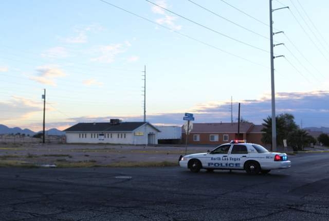 A North Las Vegas police officer sits at the intersection of Miller Avenue and Revere Street Wednesday morning, Oct. 8, 2014. A man was killed and an officer was wounded in a shootout Tuesday nigh ...