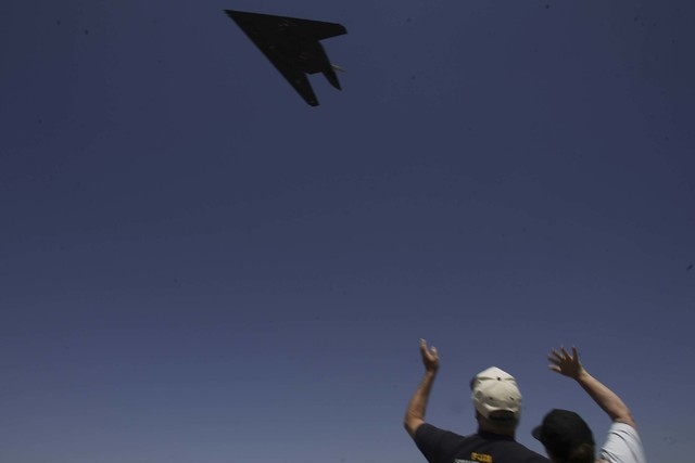 Phil and Bonnie Harris, from Landcaster, Cal, wave as a F-117A Nighthhawk stealth fighter takes off from the Lockheed Martin "Skunk Works" plant in Palmdale, California Tuesday, April 22, 2008, as ...