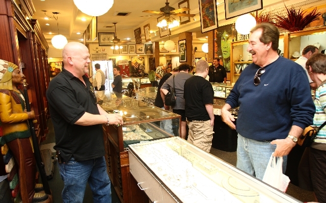 Rick Harrison, owner of the Gold & Silver Pawn Shop, talks with Bill Fiscus of Terre Haute, Ind ...