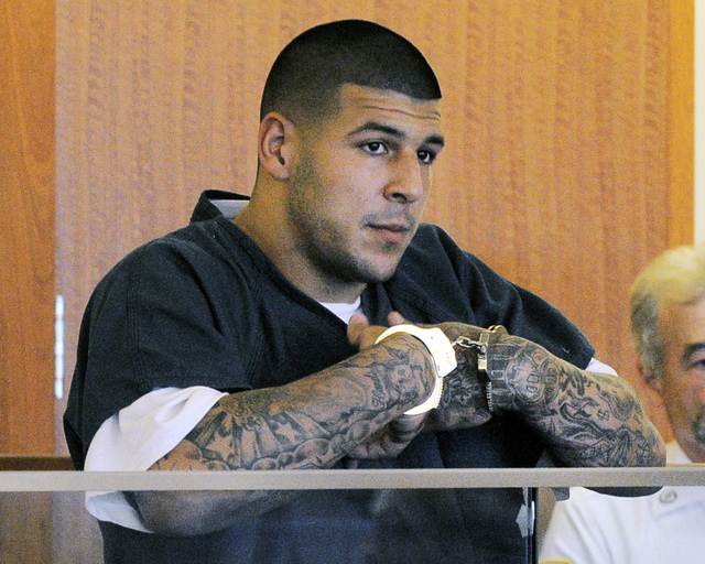 Former New England Patriots NFL football player Aaron Hernandez stands during a bail hearing in Superior Court in Fall River, Mass. Hernandez is accused of three murders in Massachusetts. Investig ...
