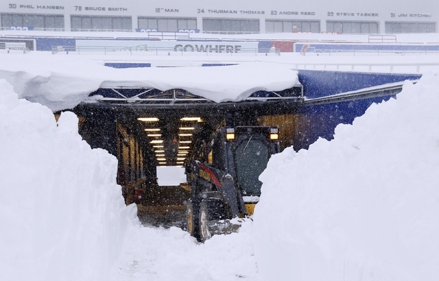 Nov 20, 2014; Orchard Park, NY, USA; After a major snow storm a grounds crew worker begins to clear snow from the football field at Ralph Wilson Stadium. (Kevin Hoffman-USA TODAY Sports)