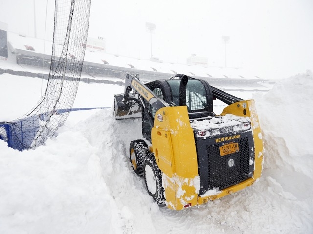 Nov 20, 2014; Orchard Park, NY, USA; After a major snow storm a grounds crew worker begins to clear snow from the football field at Ralph Wilson Stadium. (Kevin Hoffman-USA TODAY Sports)