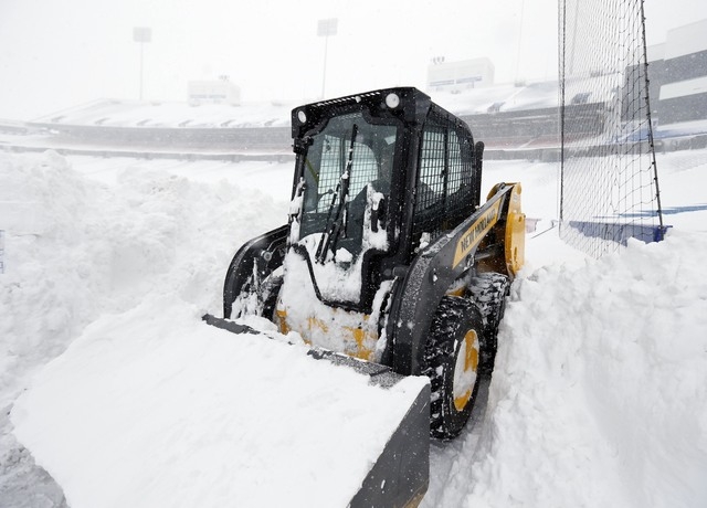 Nov 20, 2014; Orchard Park, NY, USA; After a major snow storm a grounds crew worker begins to clear snow from the football field at Ralph Wilson Stadium. (Kevin Hoffman-USA TODAY Sports)