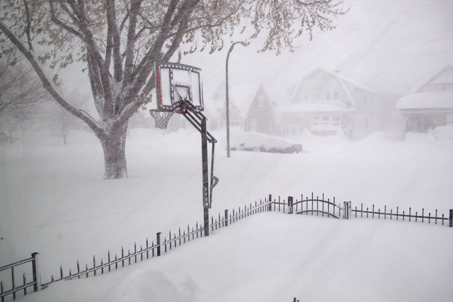 Heavy snow covers the street on Tuesday, Nov. 18, 2014, in Buffalo, N.Y. The Buffalo area found itself buried under as much as 7 feet of snow by Thursday. (AP Photo/ Carolyn Thompson)