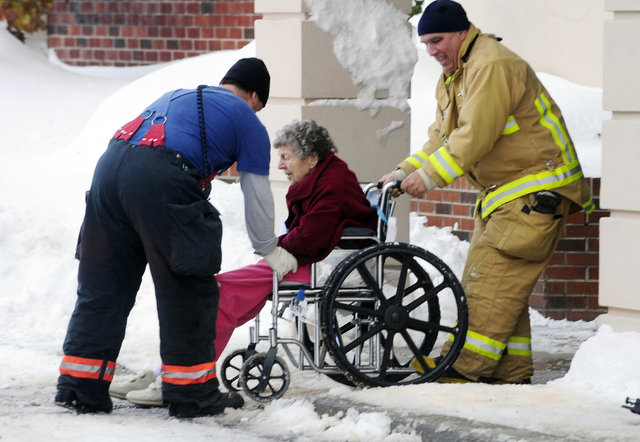Firefighters from Cheektowaga and Depew assist an elderly patient from from Garden Gate Health Care Facility to the Appletree Mall in Cheektowaga, N.Y., Thursday, Nov. 20, 2014. About 180 patients ...