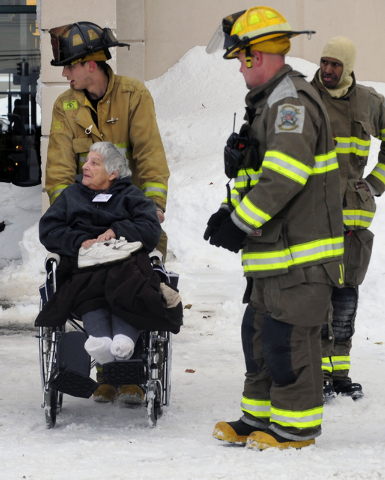 Firefighters from Cheektowaga and Depew assist a patient from from Garden Gate Health Care Facility to the Appletree Mall in Cheektowaga, N.Y., Thursday, Nov. 20, 2014. About 180 patients from the ...