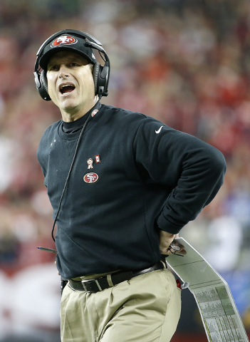 San Francisco 49ers head coach Jim Harbaugh stands on the sideline during the first half of an NFL football game against the Seattle Seahawks in Santa Clara, Calif., Thursday, Nov. 27, 2014. (AP P ...