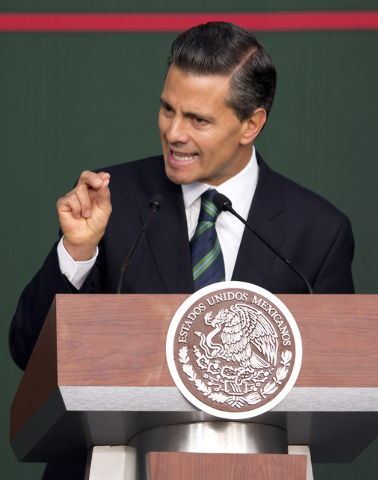Mexico's President Enrique Pena Nieto speaks during a ceremony at the National Palace in Mexico City, Thursday, Nov. 27, 2014. Mexico's president announced a new anti-crime plan that includes prop ...