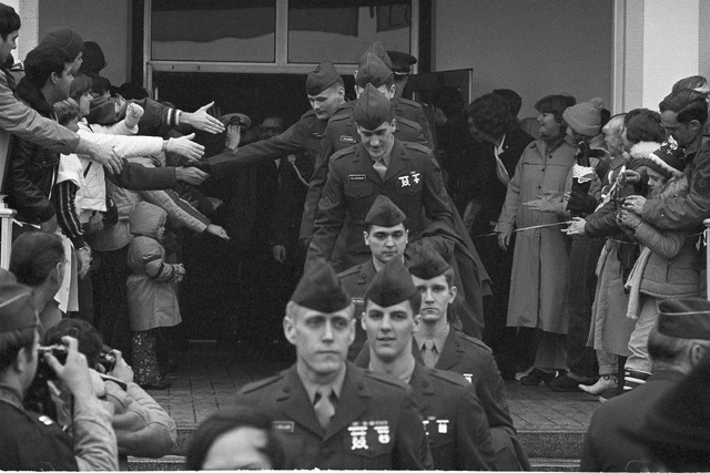 Wearing their brand new uniforms, Marines among the 52 former hostages leave the main entrance of Wiesbaden Air Force hospital Sunday, Jan. 25, 1981, en route to the buses that brought them to Fra ...