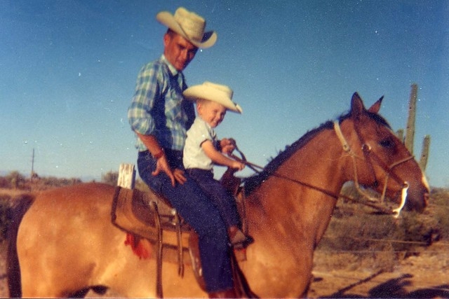 In a photo from September 1964, Gordon Young rides a horse with his son Robert, 3, in Arizona. Gordon was killed about two months later when Bonanza Airlines Flight 114 crashed into a mountain sou ...