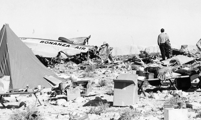 A man stands among the wreckage of Bonanza Air Lines Flight 114, which plowed into mountain just south of Las Vegas on Nov. 15, 1964, killing all 29 people on board. The crash was initially blamed ...