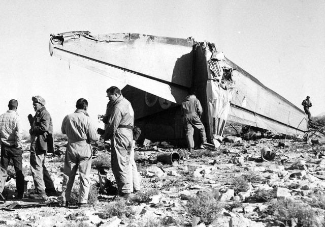 Investigators gather near the tail section of Bonanza Air Lines Flight 114, which crashed into a mountain just south of Las Vegas on Nov. 15, 1964, killing all 29 people on board. (Courtesy of Scr ...