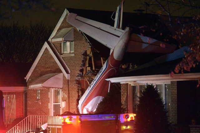 A small twin-engine cargo plane crashed into a home on Chicago's southwest side early Tuesday morning, Nov. 18, 2014, shortly after taking off from Midway International Airport. A fire department  ...