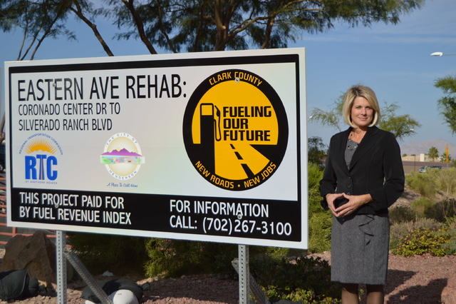 Tina Quigley, general manager of the Regional Transportation Commission, shows off a sign at St Rose Parkway and South Eastern Avenue that is being funded through the fuel tax indexing program.