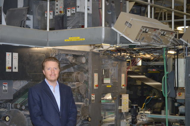 Allan Creel Jr., president of Creel Printing, stands in front of one of many presses at Creel Printing. (Stephanie Annis/Las Vegas Business Press)