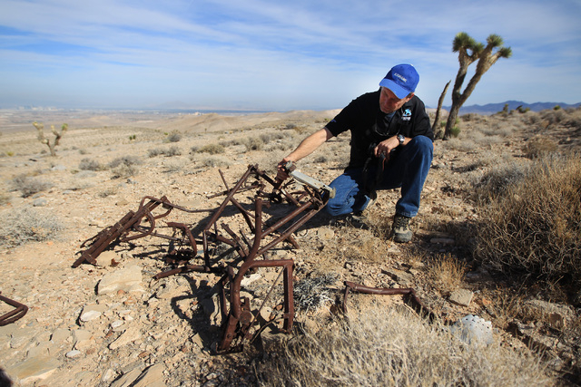 Doug Scroggins looks over wreckage at the crash site of Bonanza Flight 114 about 15 miles southwest of McCarran International Airport Thursday, Nov. 13, 2014. (Sam Morris/Las Vegas Review-Journal)