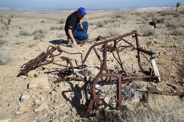 Doug Scroggins looks over wreckage at the crash site of Bonanza Flight 114 about 15 miles southwest of McCarran International Airport Thursday, Nov. 13, 2014. (Sam Morris/Las Vegas Review-Journal)