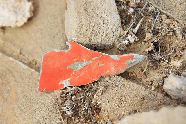 A piece of wreckage in Bonanza's orange color scheme is seen at the crash site of Bonanza Flight 114 about 15 miles southwest of McCarran International Airport Thursday, Nov. 13, 2014. (Sam Morris ...