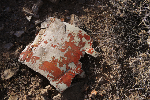 A piece of wreckage in Bonanza's orange color scheme is seen at the crash site of Bonanza Flight 114 about 15 miles southwest of McCarran International Airport Thursday, Nov. 13, 2014. (Sam Morris ...