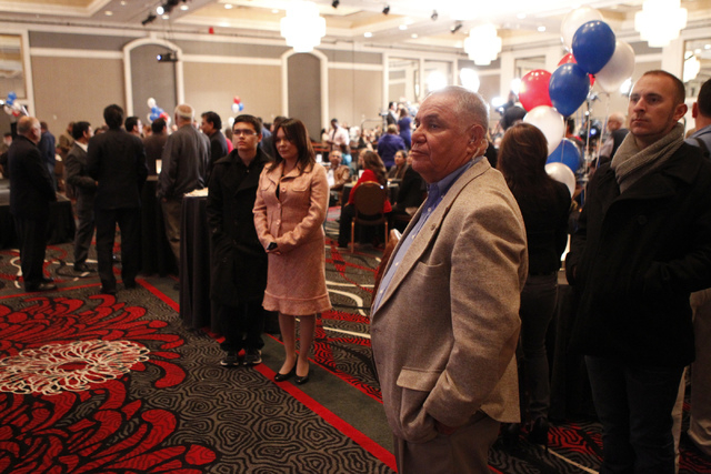 Security guard Manuel Tarango, center, and Democratic Party supporter Matt Christensen, right, watch the Nevada GOP watch party on TV during the election watch party for the Nevada State Democrati ...