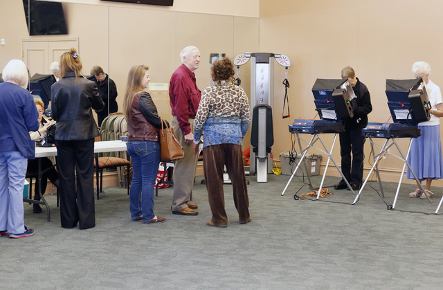 Juana Leia Jordan, center, a Clark County Election Election Department's worker, talks to voters as they wait in line to cast their vote Tuesday, Nov. 4, 2014, at Las Ventanas Community Center, 10 ...