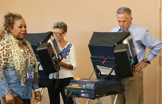 Clark County sheriff candidate Joe Lombardo, right, casts his vote as Juana Leia Jordan, left, an election poll worker, looks on  Tuesday, Nov. 4, 2014, at Las Ventanas Community Center, 10401 W.  ...