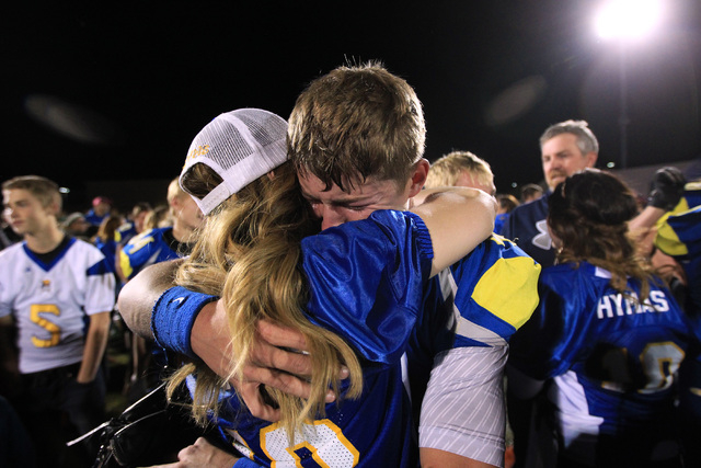 Moapa Valley quarterback Zach Hymas gets a big hug from his mother Becky Hymas after the Pirates defeated Desert Pines in their Division 1-A championship game Saturday, Nov. 22, 2014 at Bishop Gor ...