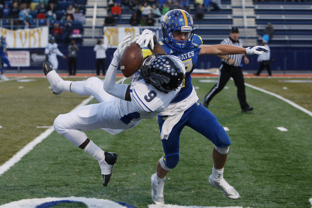 Moapa Valley defensive back Cole Mulcock breaks up a pass intended for Desert Pines wide receiver Andre Watts during their Division 1-A championship game Saturday, Nov. 22, 2014 at Bishop Gorman.  ...