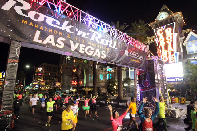 Runners cross the half marathon finish line in the Rock 'n' Roll Las Vegas  Marathon and half marathon on the Strip on Sunday, Nov. 16, 2014. (K.M.  Cannon/Las Vegas Review-Journal) | Las