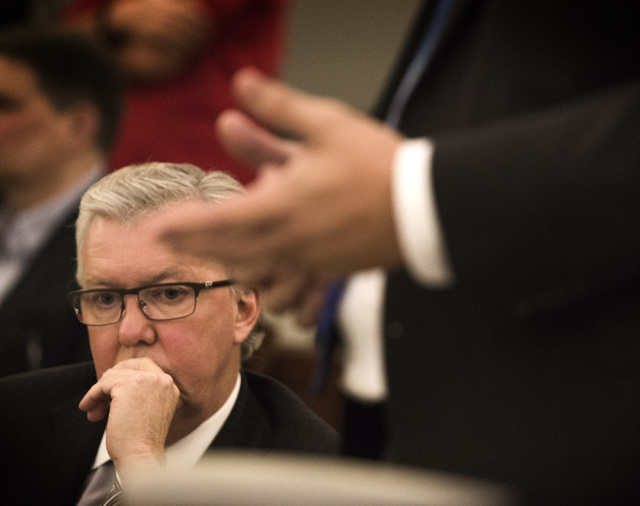 Don Campbell, left, representing Uber, listens while Senior Deputy Attorney General David Newton speaks during a hearing on the ride-share company at the Regional Justice Center on Wednesday, Oct. ...