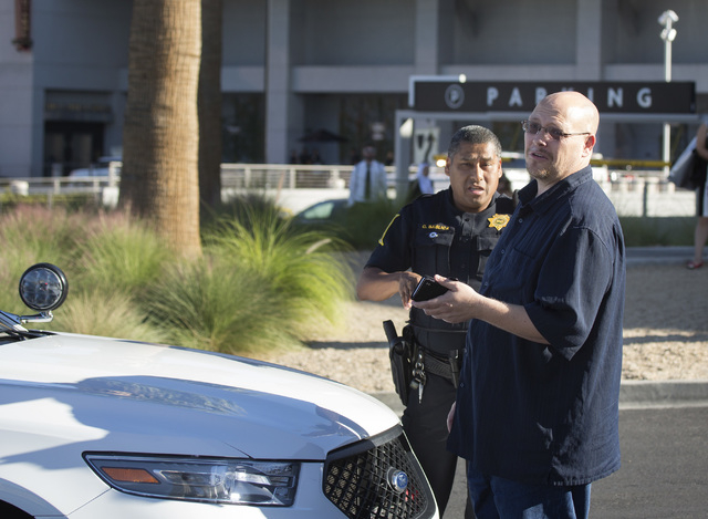 Uber driver Michael Elsner, right, gets detained by law enforcement officer in front of the Fashion Show  on Friday, Oct. 24, 2014. (Jeff Scheid/Las Vegas Review-Journal)