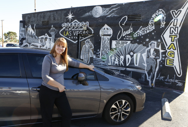 Uber driver Maria Nekljudova of Las Vegas poses for photo near Las Vegas mural at 1441 Las Vegas Blvd. South on Thursday, Oct.  23, 2014, near the "Welcome to Downtown Las Vegas" sign. (Bizuayehu  ...