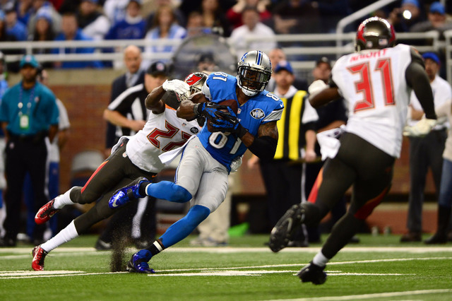NFC Wild Card: Detroit Lions -- Wide receiver Calvin Johnson (81) makes a catch while being defended by Tampa Bay Buccaneers cornerback Johnthan Banks (27) during the fourth quarter at Ford Field  ...