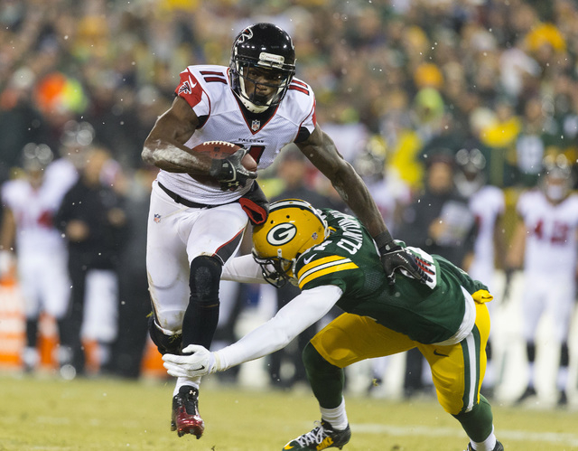 NFC South: Atlanta Falcons -- Wide receiver Julio Jones (11) carries the football as Green Bay Packers safety Ha Ha Clinton-Dix (21) defends during the first quarter at Lambeau Field on Dec. 8, 20 ...