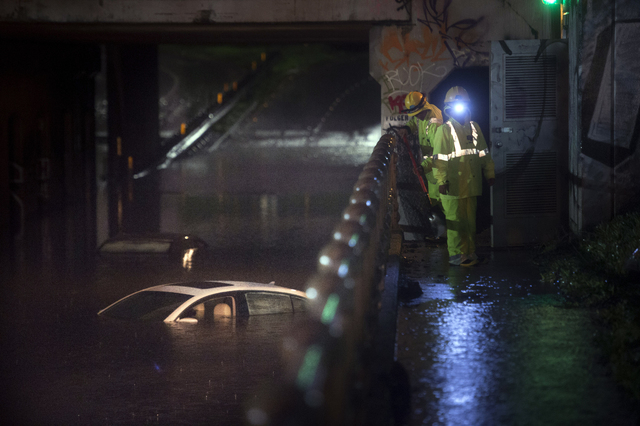 Water covers one of several vehicles stranded in an Ashby Ave. in Berkeley, Calif., on Thursday, Dec. 11, 2014. A powerful storm churned through Northern California Thursday, knocking out power to ...