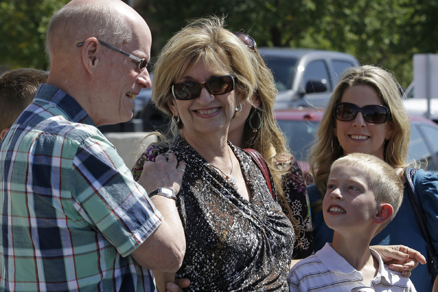 In this Aug. 29, 2014 file photo, Jan Harding, center, is accompanied by her husband, Jim, left, and other family members as she speaks with reporters in Salt Lake City. Jan Harding has reached a  ...