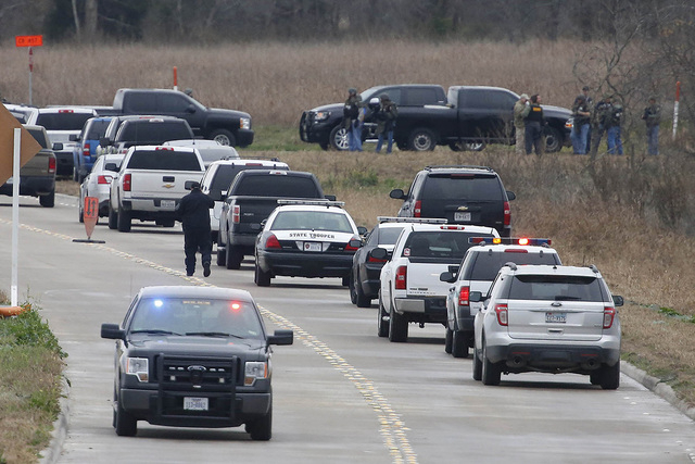 Law enforcement officers set up near a command post while looking  for a gunman who shot a weather forecaster during an altercation outside the KCEN-TV studio along Interstate 35 between Waco and  ...