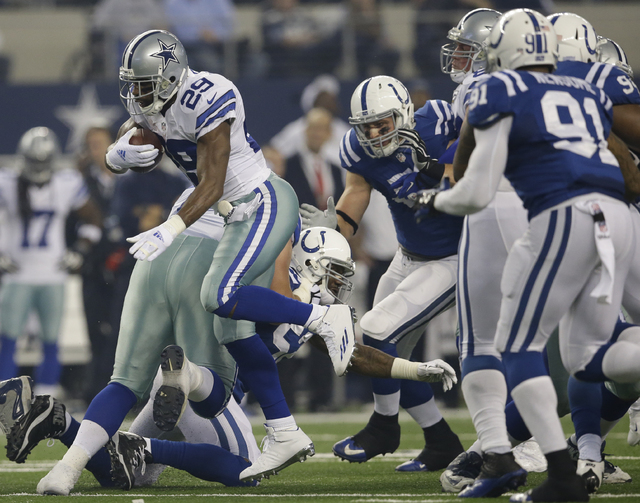 Dallas Cowboys running back DeMarco Murray (29) breaks through the line of scrimmage on a running play during the first half of an NFL football game against the Indianapolis Colts, Sunday, Dec. 21 ...