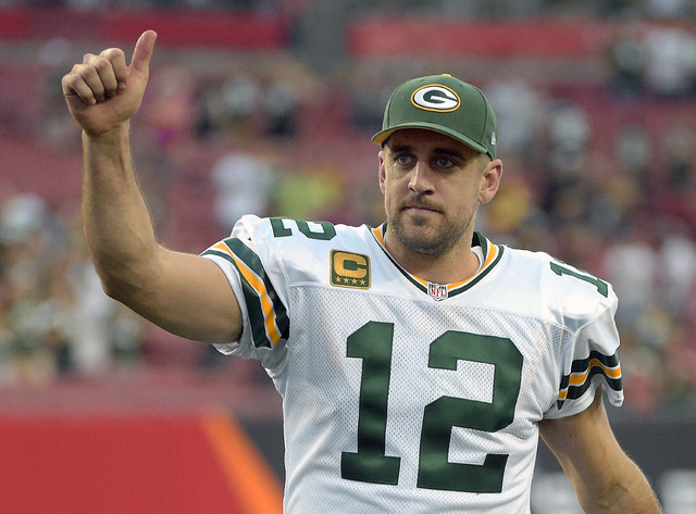 Green Bay Packers quarterback Aaron Rodgers (12) gives the thumbs