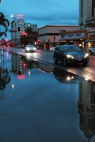 Motorists drive down a flooded street on Friday, Dec. 12, 2014  in Bakersfield, Calif. Rain fell at the rate of 1 to 2 inches an hour, triggering flash flooding, the National Weather Service said. ...